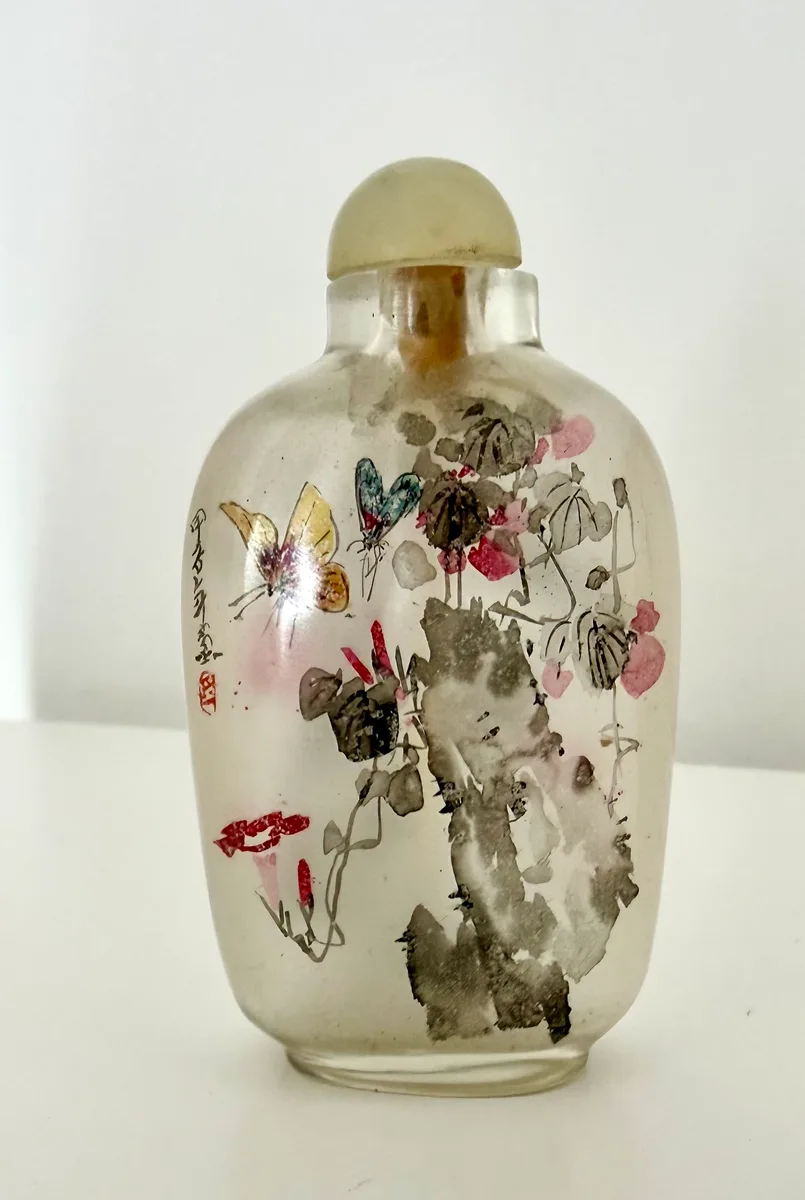 Chinese inside-painted glass snuff bottle with butterfly and flowers, jade-tone stopper, silk box case. (7 cm approximately)